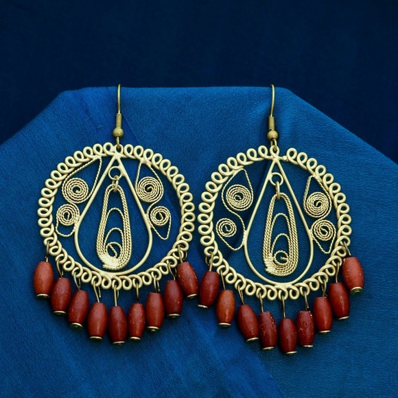 Gold tone hoop earrings with dangling wood beads. - Picture 1 of 2